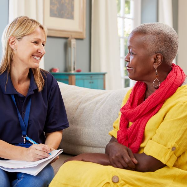 Female Social Worker Talking To A Lady600x600
