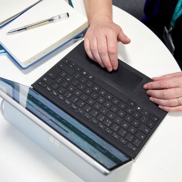 Someone typing on a laptop