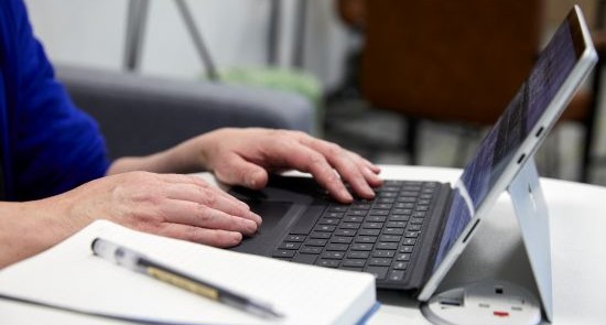 Hands typing on computer)