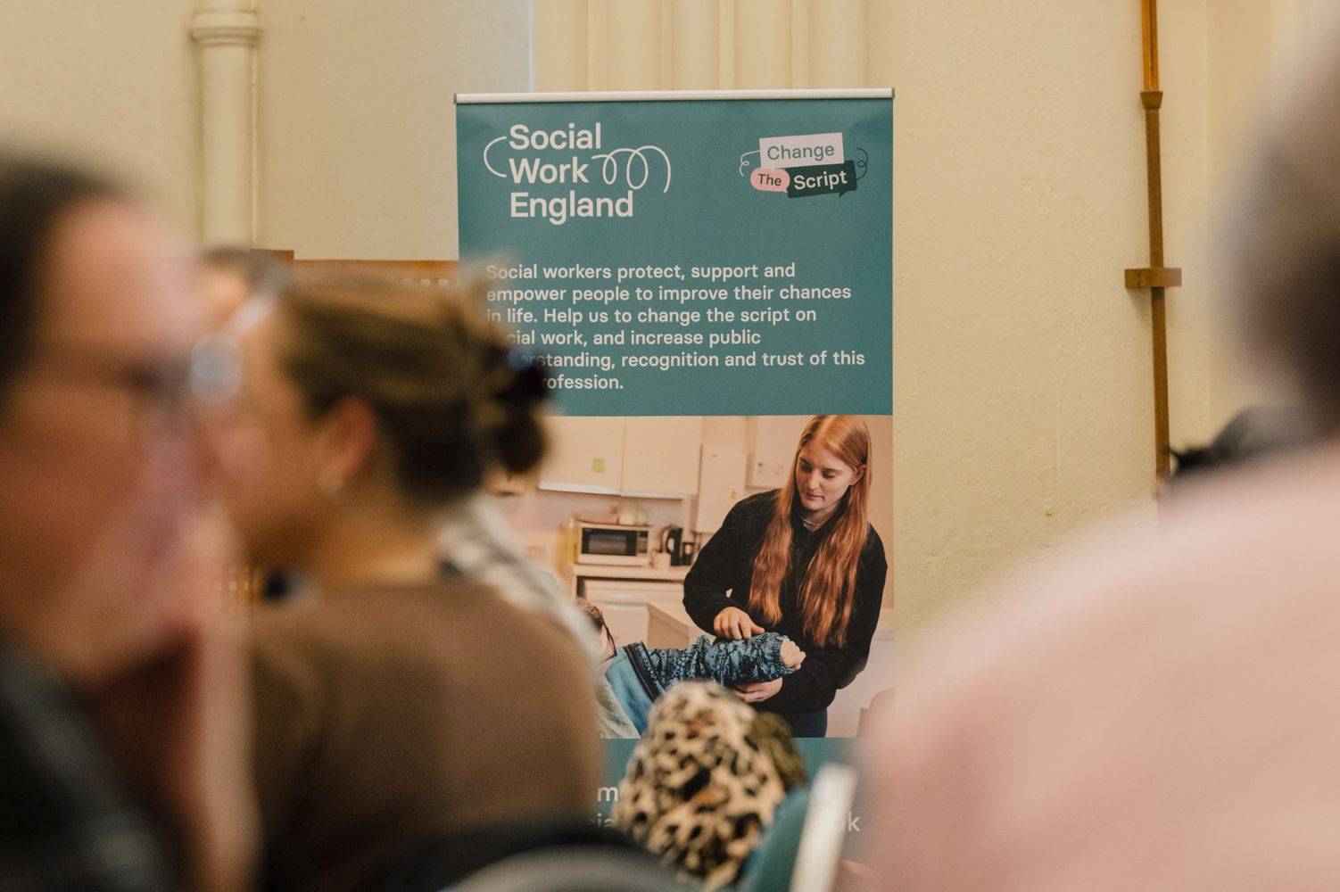 A Social Work England banner placed in front of a wall