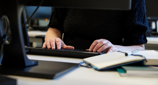 A person typing on a keyboard)